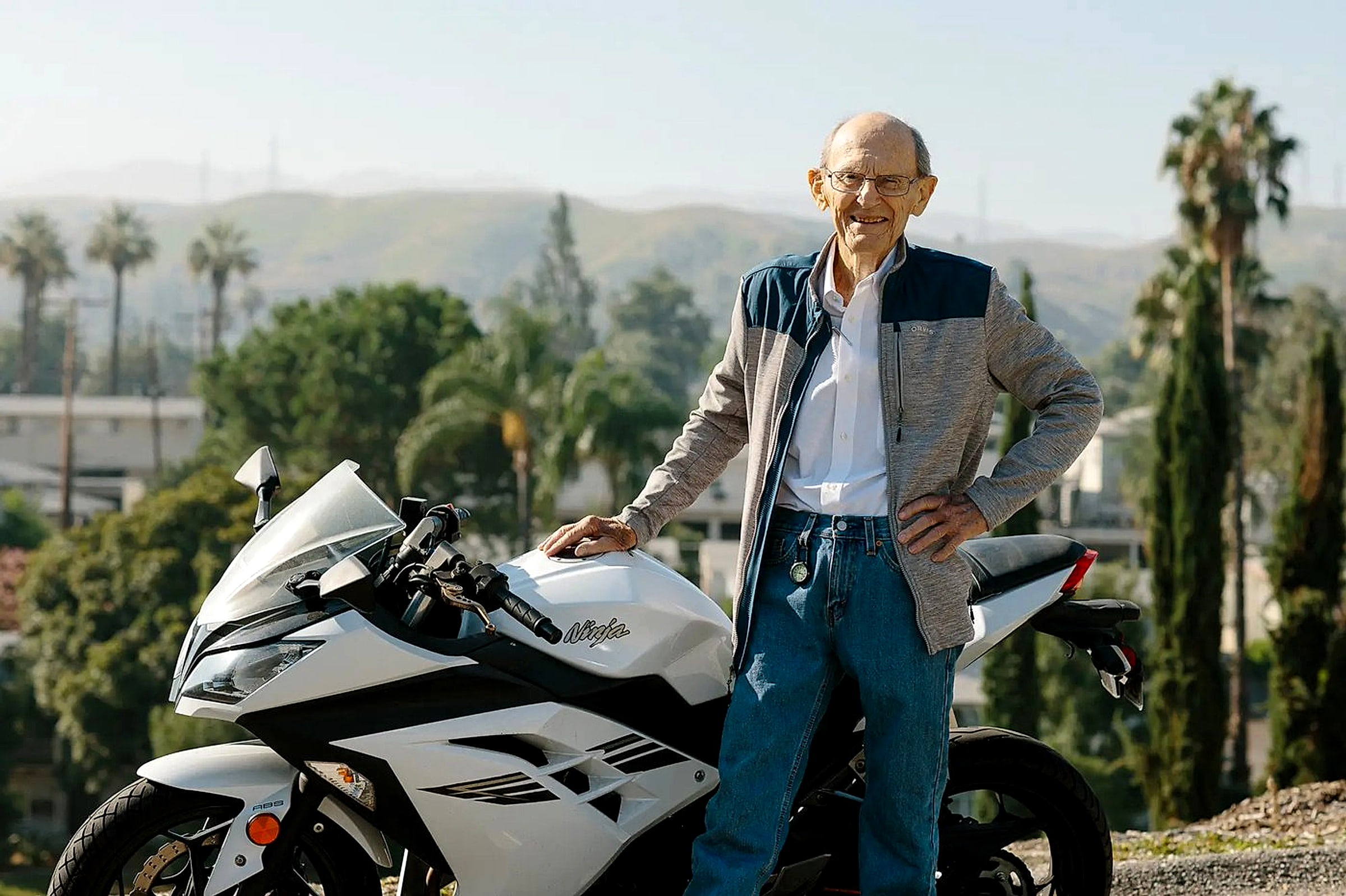 David Baylink standing beside his Kawasaki Ninja in the hills above Loma Linda
